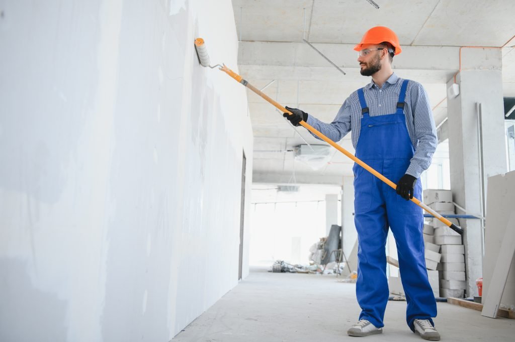 painter man painting the wall, with paint roller