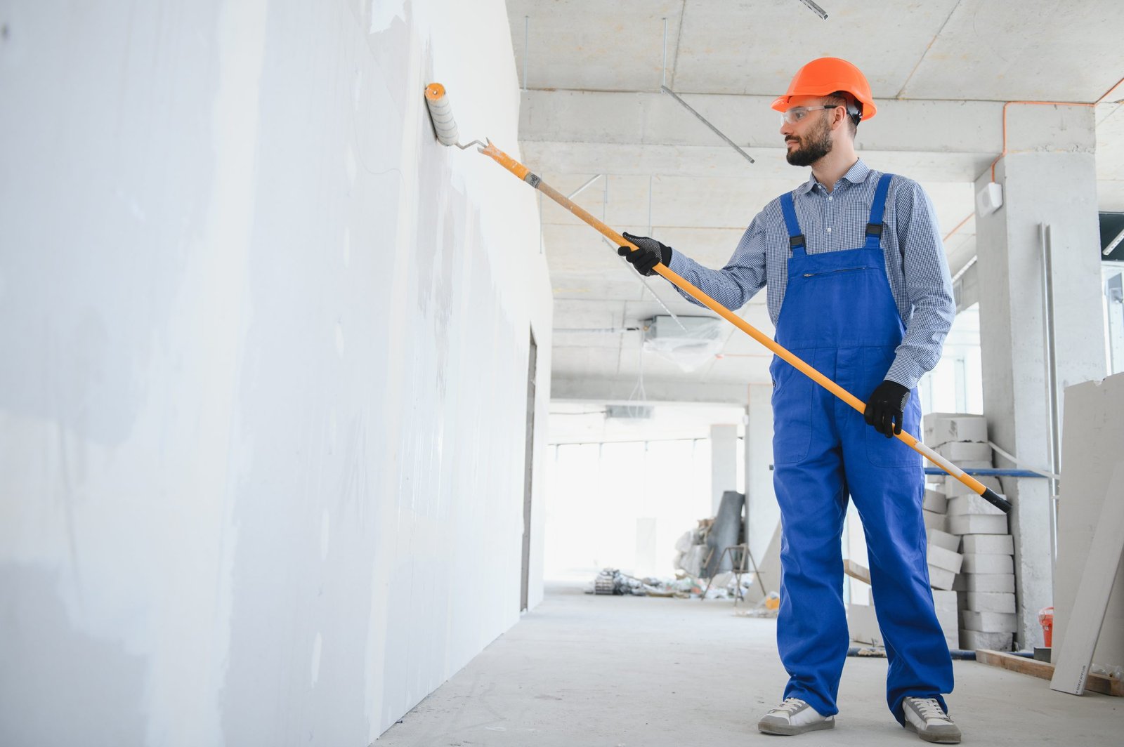 painter man painting the wall, with paint roller